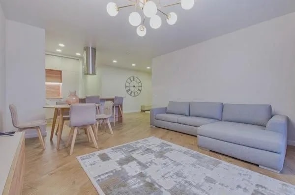 apartment space couch rug table with chairs
